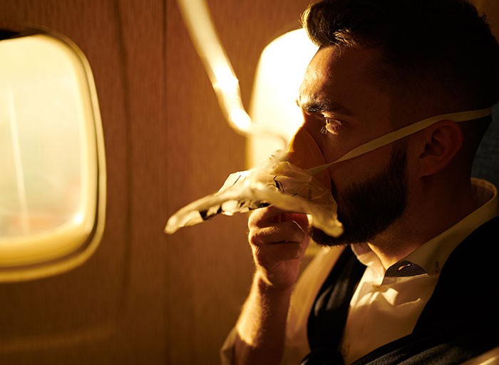 Man Breathing Oxygen in Plane