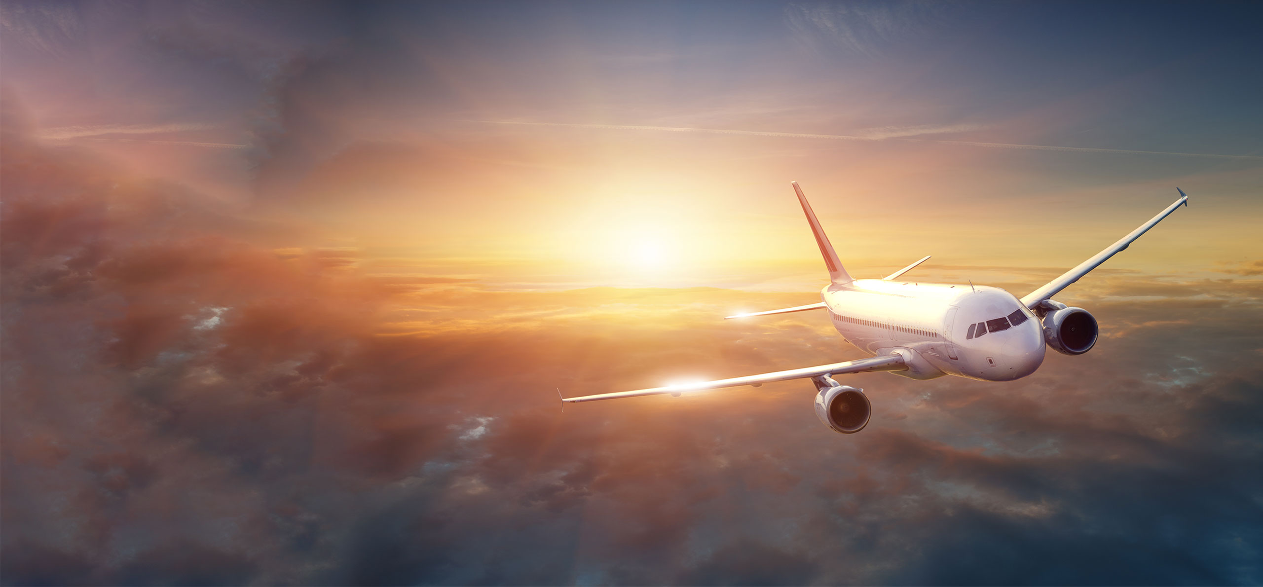 Airplane in the sky at sunset